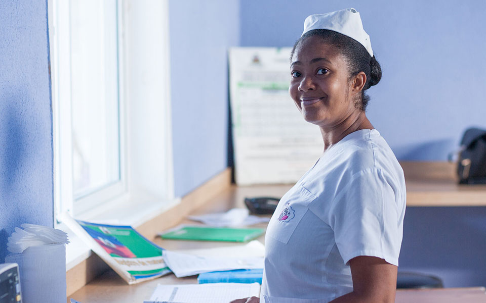 A nurse smiles as she works in a health facility of Haiti