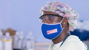 A health worker works in PPE. 