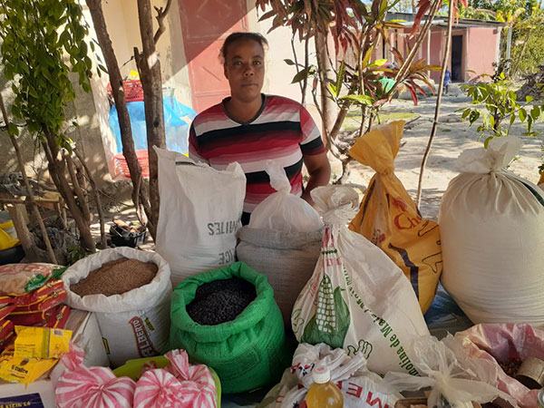 Denar is a member of CMMB Haiti MUSO groups. Here she stands at her market stand. 